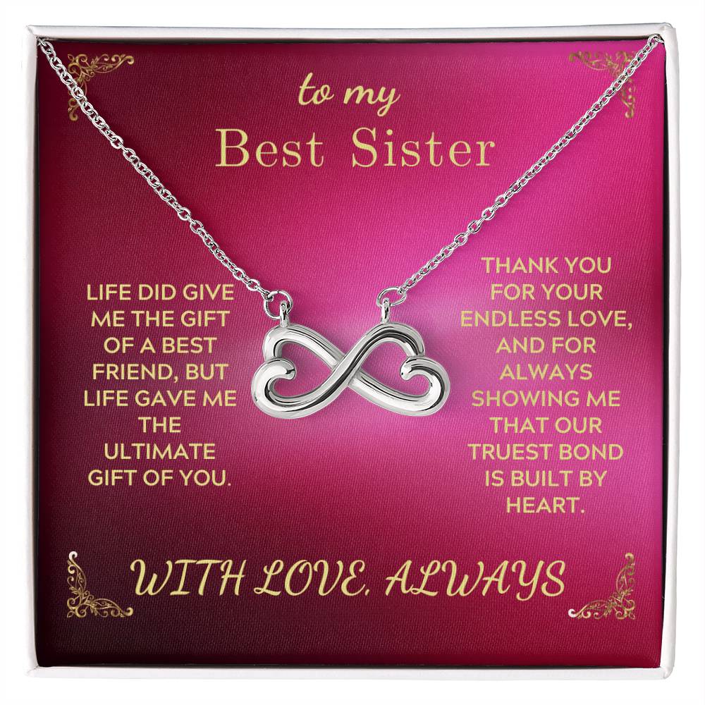 Silver-tone infinity heart pendant necklace in gift box, chain draped across card