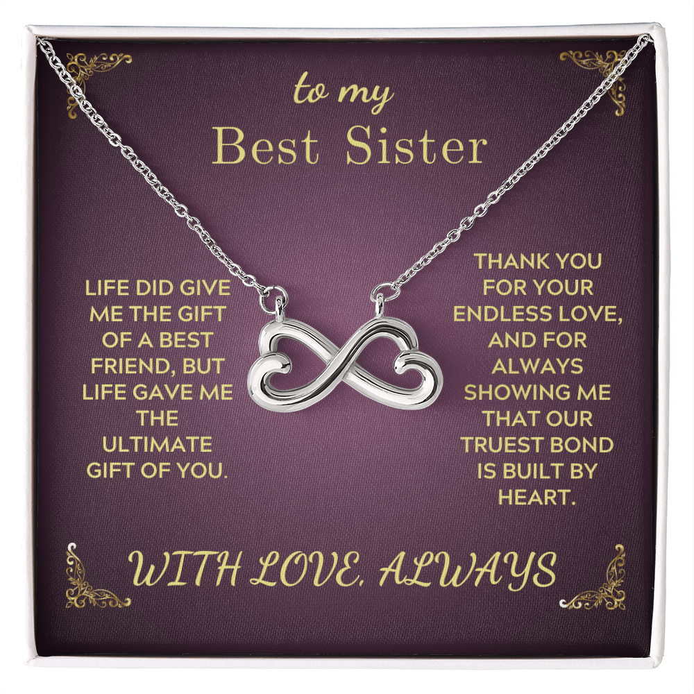 Silver heart-and-infinity pendant necklace with chain on purple gift box insert