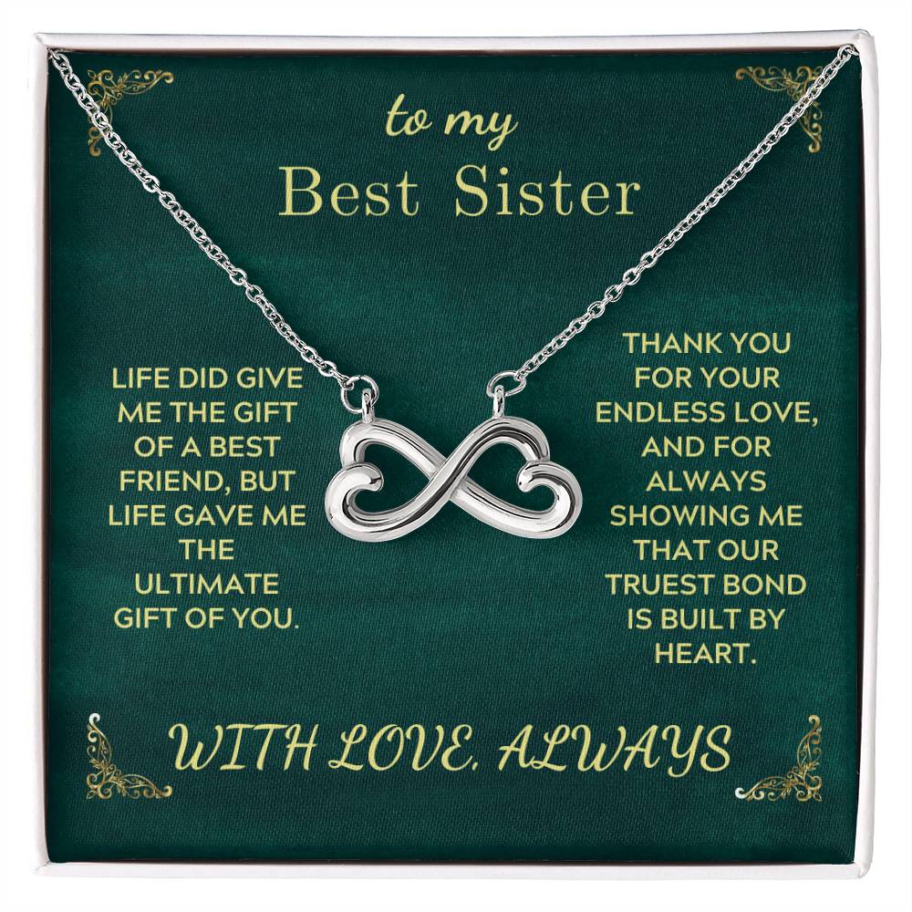 Silver infinity heart sister necklace on green gift card, in gift box