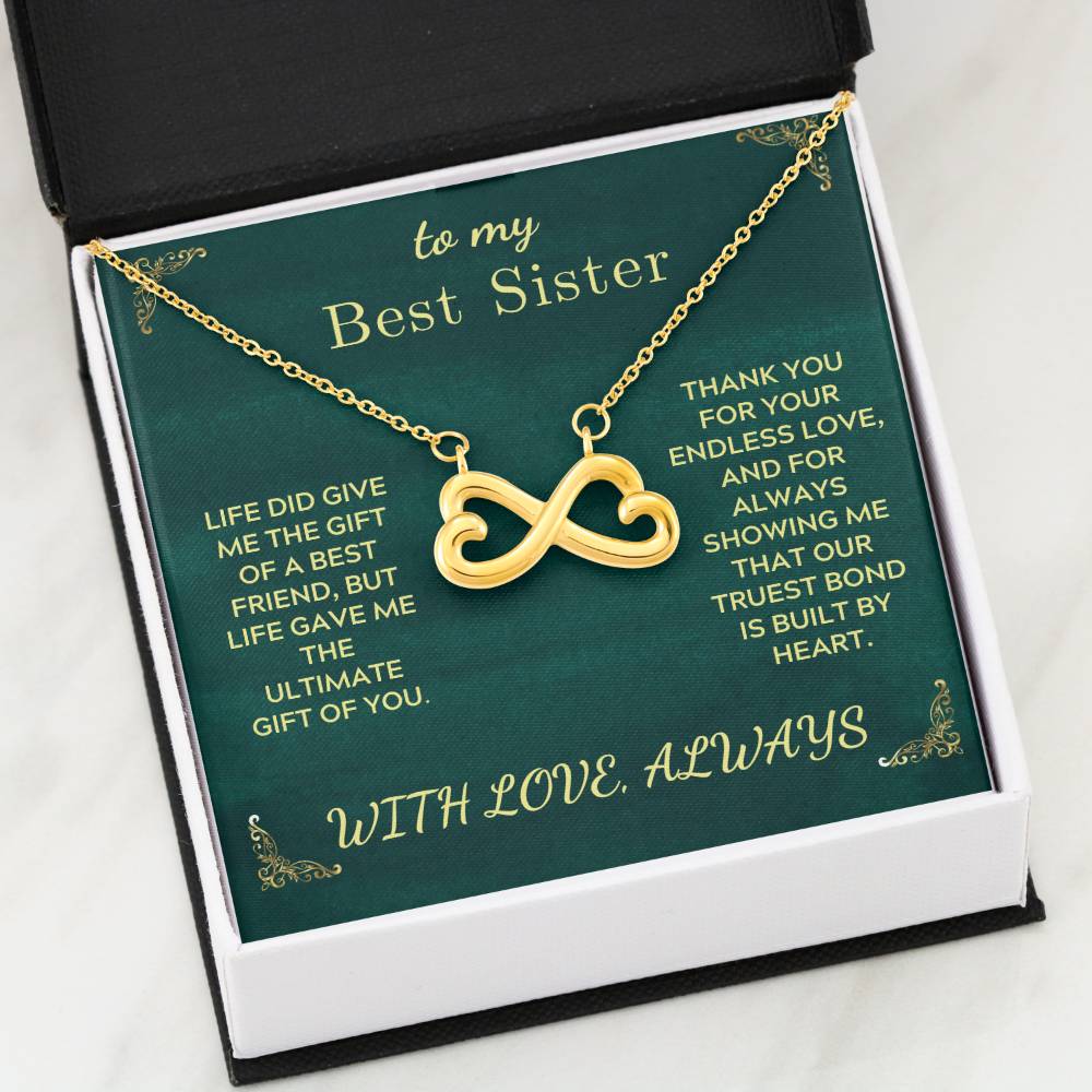 Best sister pendant necklace with infinity heart charm over green gift card
