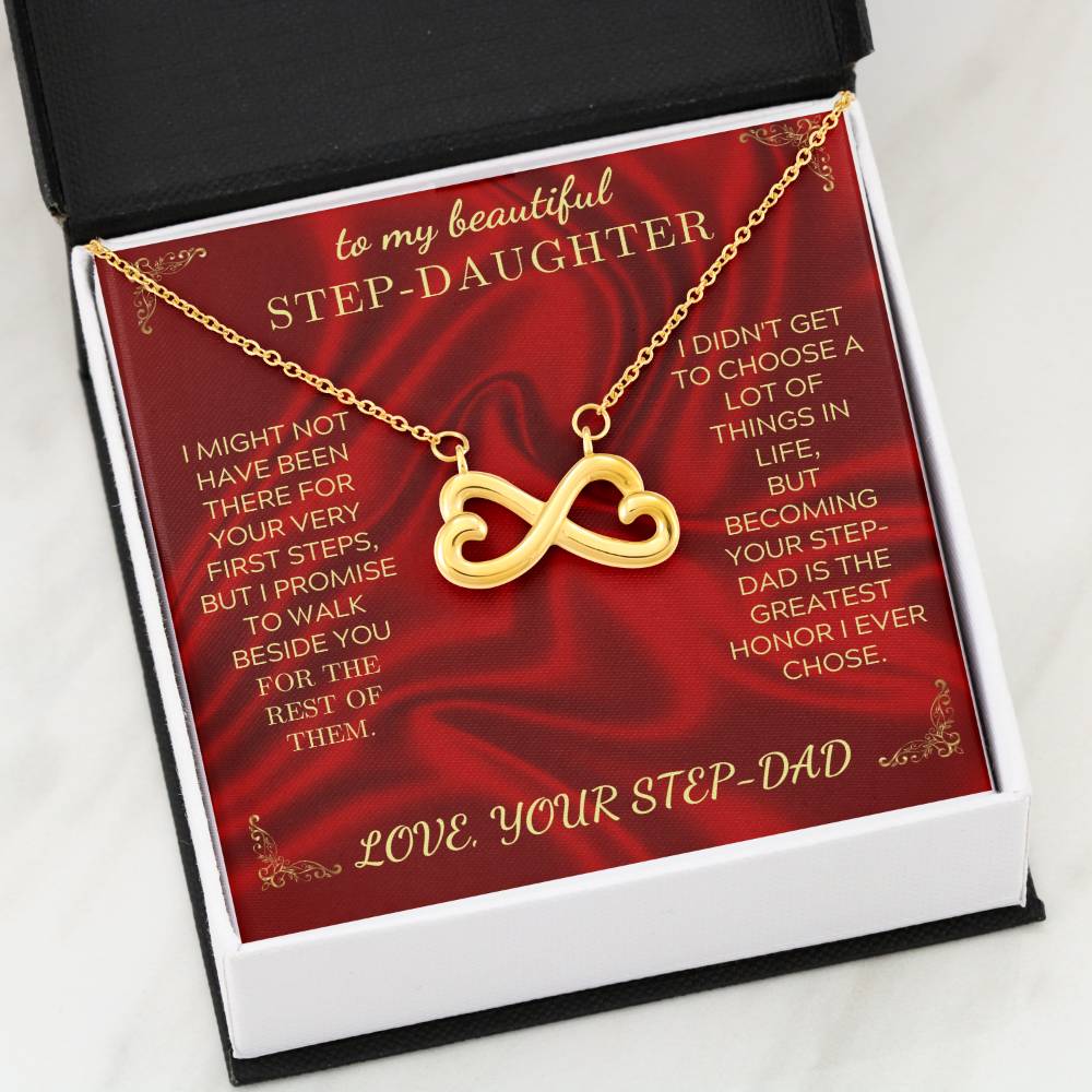 Gold heart-infinity pendant necklace on a red card inside a black gift box