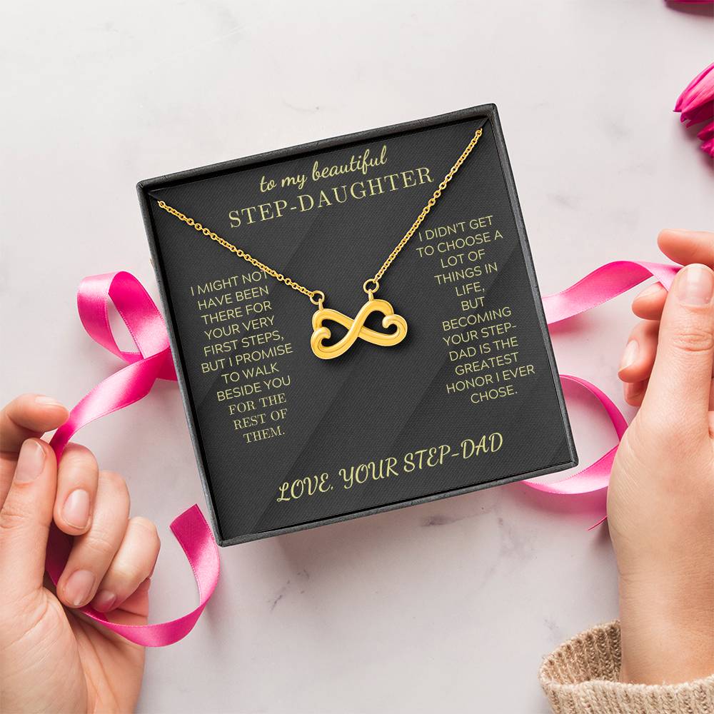 Gold infinity heart pendant necklace on black velvet card in open gift box