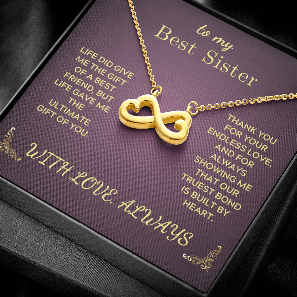 Gold heart-and-infinity pendant necklace on purple gift box insert