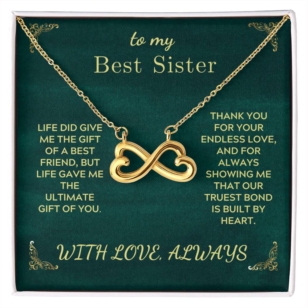 Gold-tone infinity heart sister necklace on green gift card, in gift box
