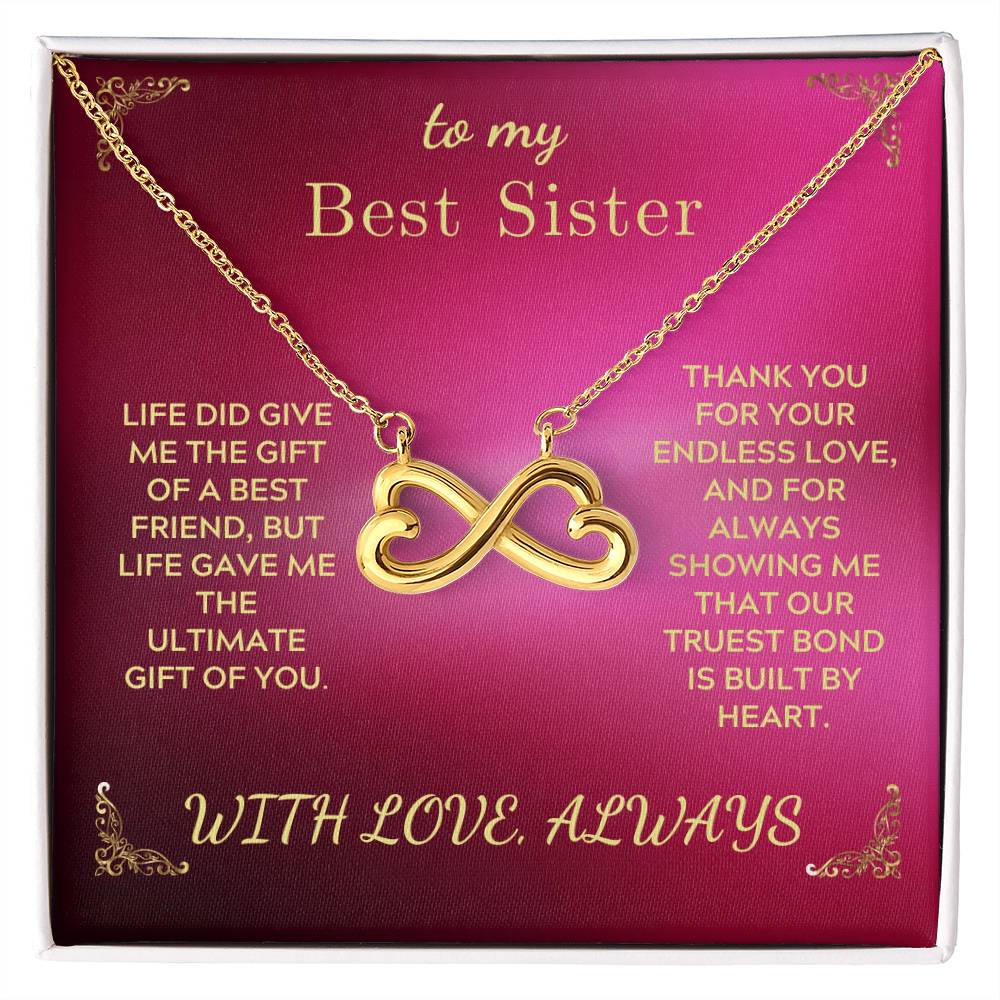 Gold-tone infinity heart pendant necklace in gift box, chain draped across card