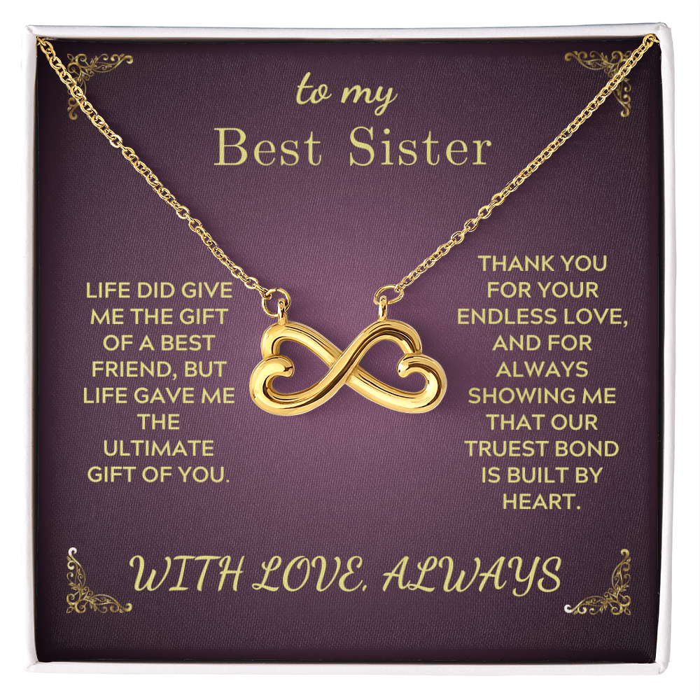 Gold heart-and-infinity pendant necklace with chain on purple gift box insert