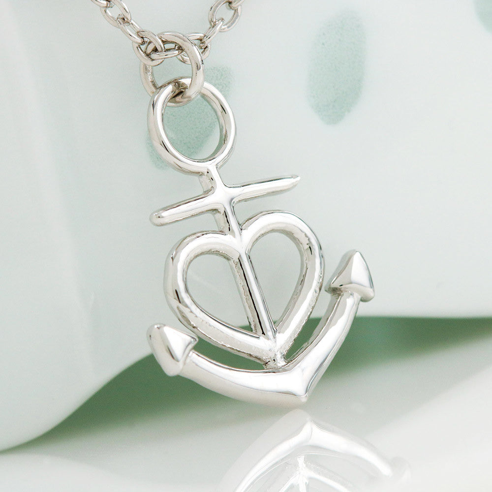 Silver-tone anchor heart pendant necklace on chain, close-up on charm