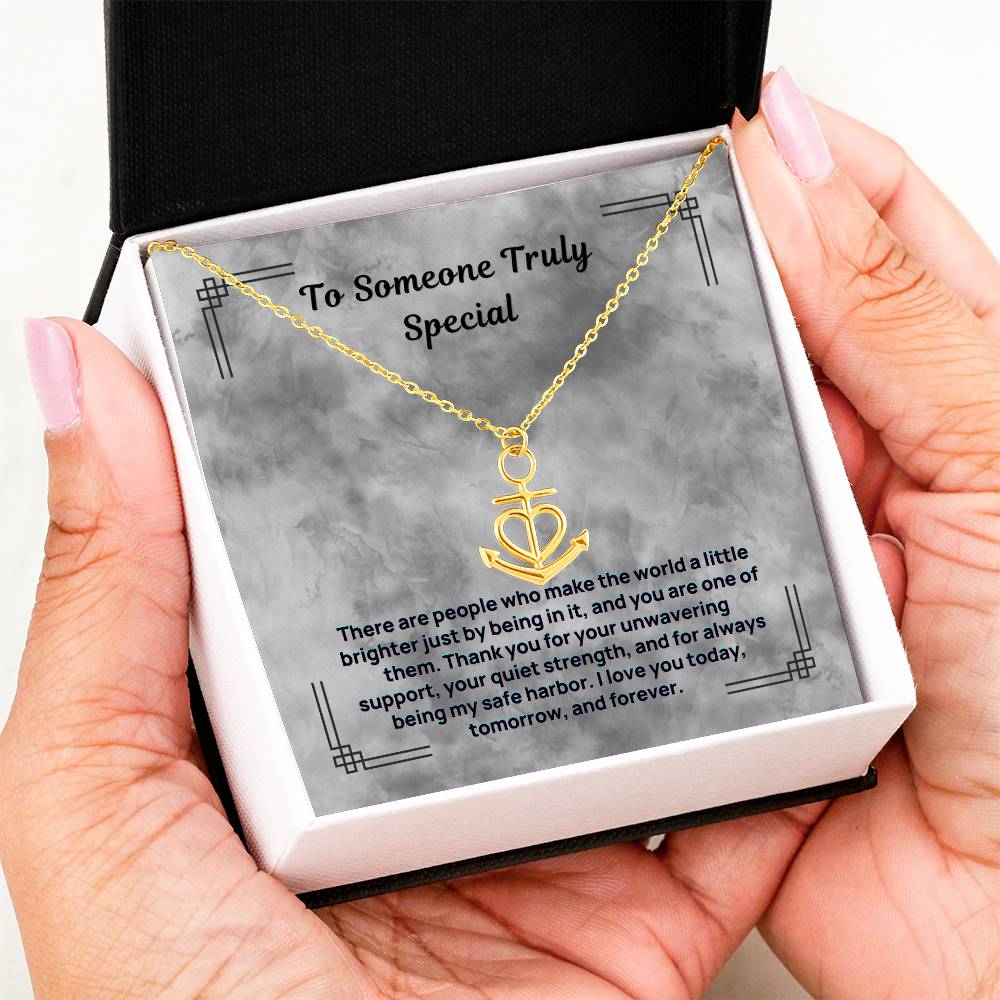 Gold-tone anchor and heart pendant necklace shown in a gift box