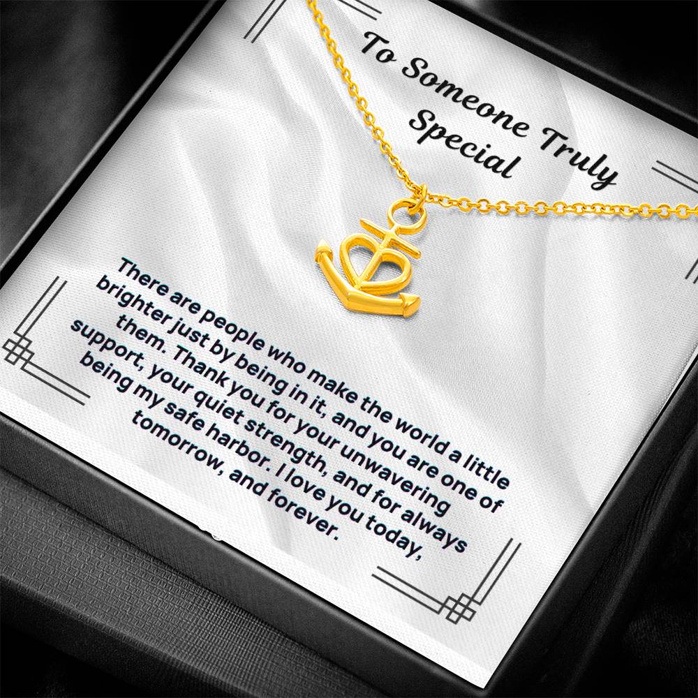 Gold-tone anchor-and-heart pendant necklace on white gift card display