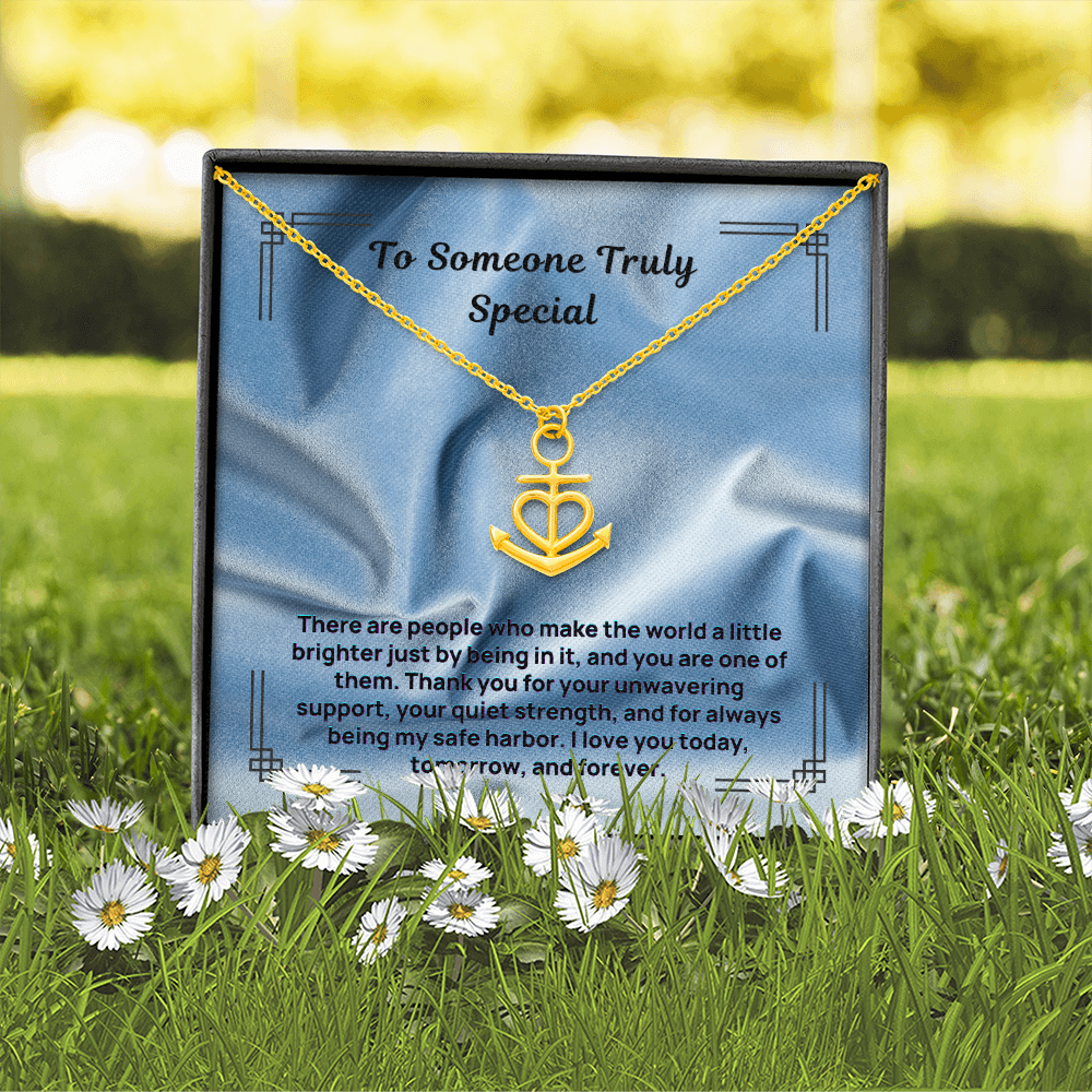 Gold anchor and heart pendant necklace with a linked chain, shown in a gift box.