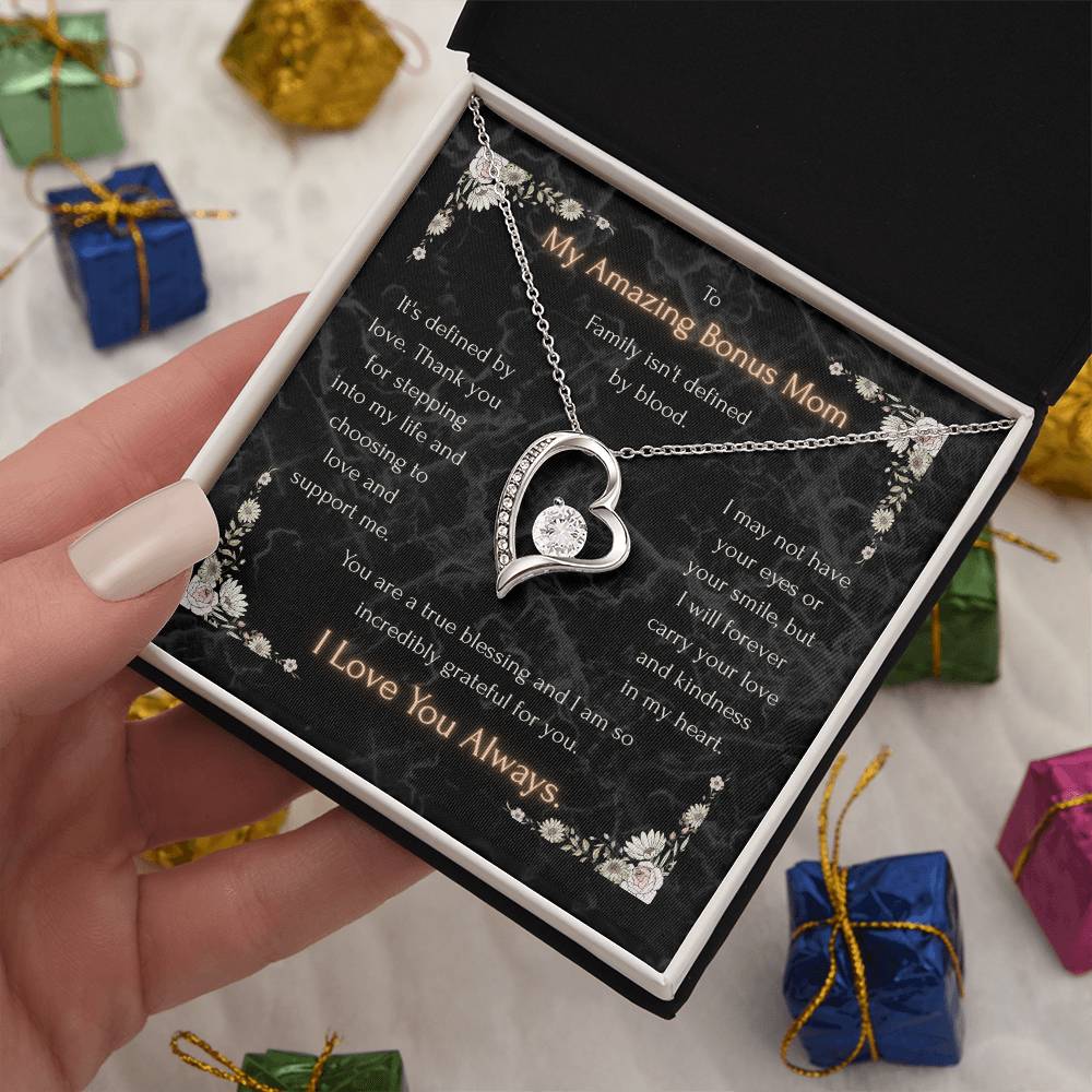 Silver heart pendant necklace with sparkling heart detail on a decorative message card