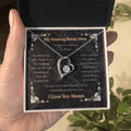 Silver heart pendant necklace with clear stone center on a message card in a box