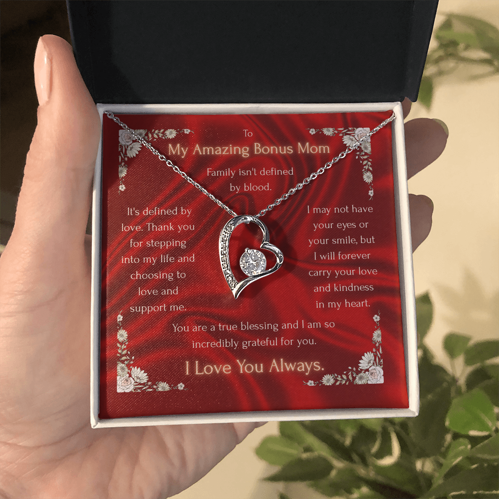 Heart pendant necklace with red charm card in a white-trimmed gift box, silver tone.