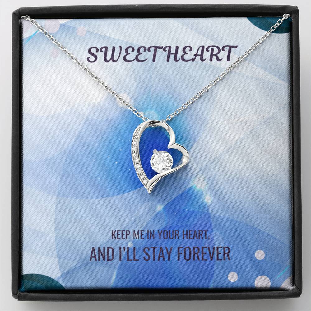 Silver-tone heart pendant necklace with clear center stone and sparkling border