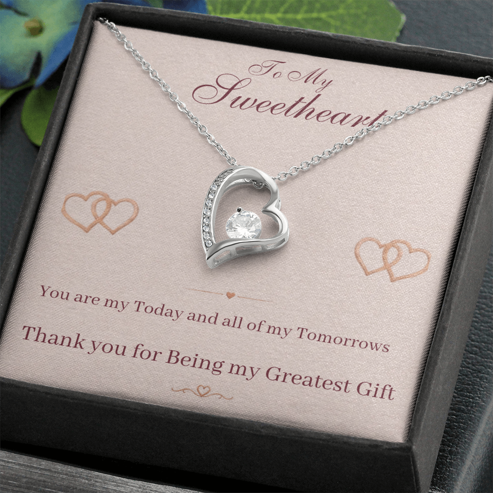 Silver heart pendant necklace on display card inside dark gift box