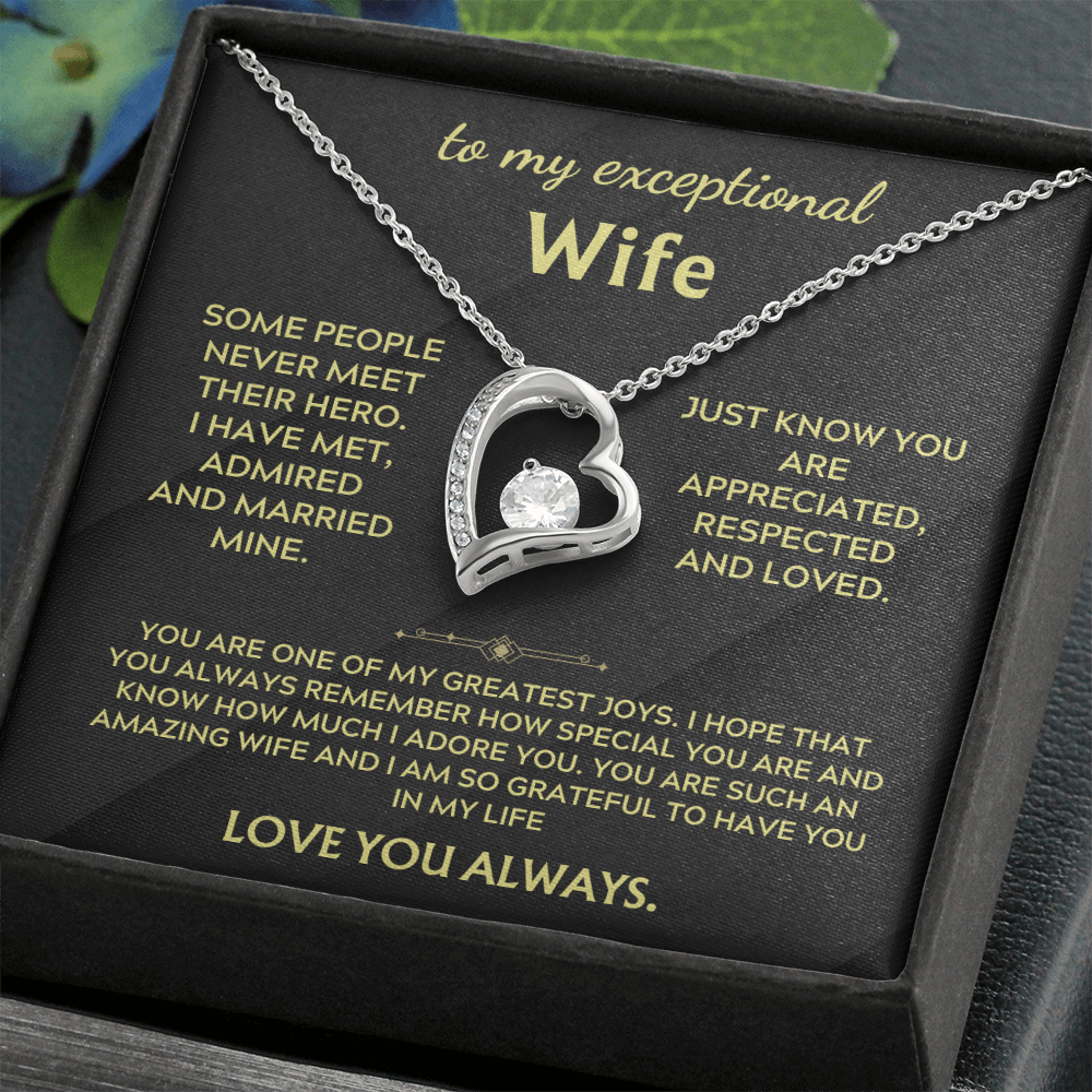 Necklace in box with silver heart pendant and chain on black printed insert