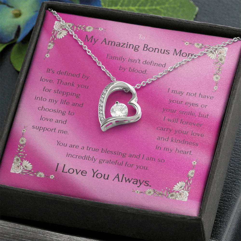 Silver heart pendant necklace with rhinestone outline on a pink message card in box