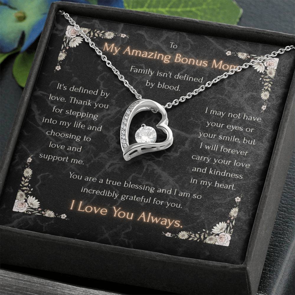 Silver heart pendant necklace with clear center stone and chain on a gift card