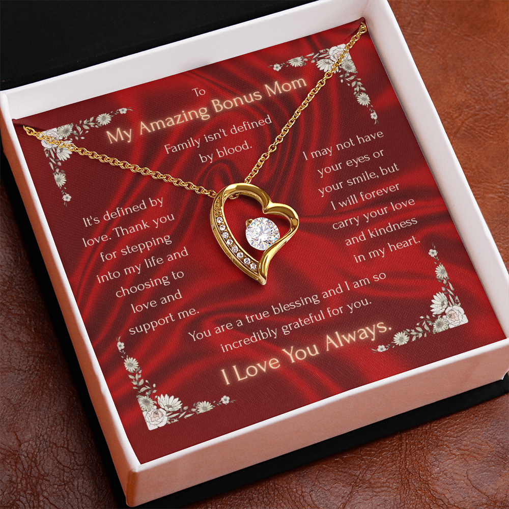 Red gift box showing gold-tone heart pendant necklace with crystal heart charm
