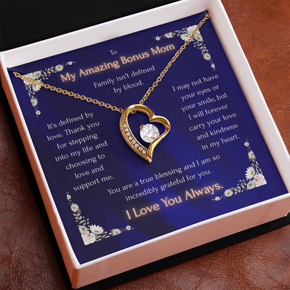 Gold-tone heart pendant necklace with blue enamel edge and round CZ center in box