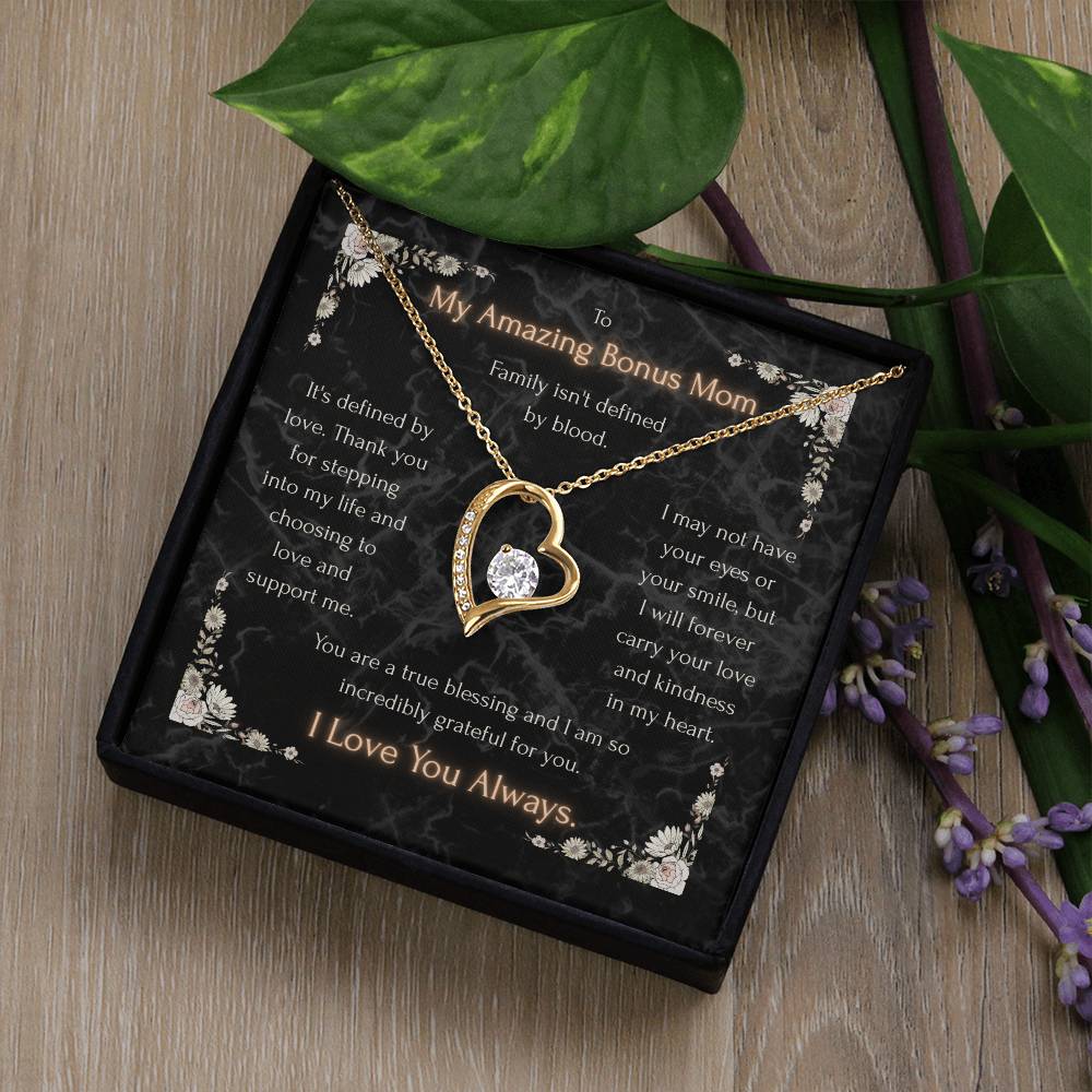 Gold heart pendant necklace with clear stone and sparkling edges on a message card
