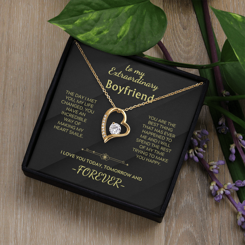 Heart pendant necklace with clear stone on gold chain in a black gift box