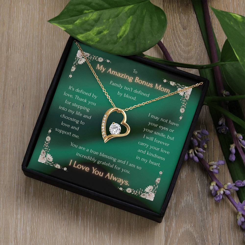 Gold heart pendant necklace with crystal accents, shown in a gift box