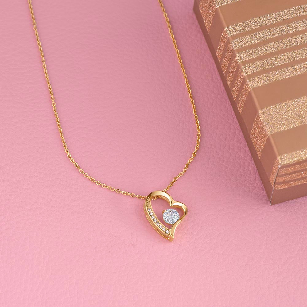 Gold heart pendant necklace with small clear crystal accents