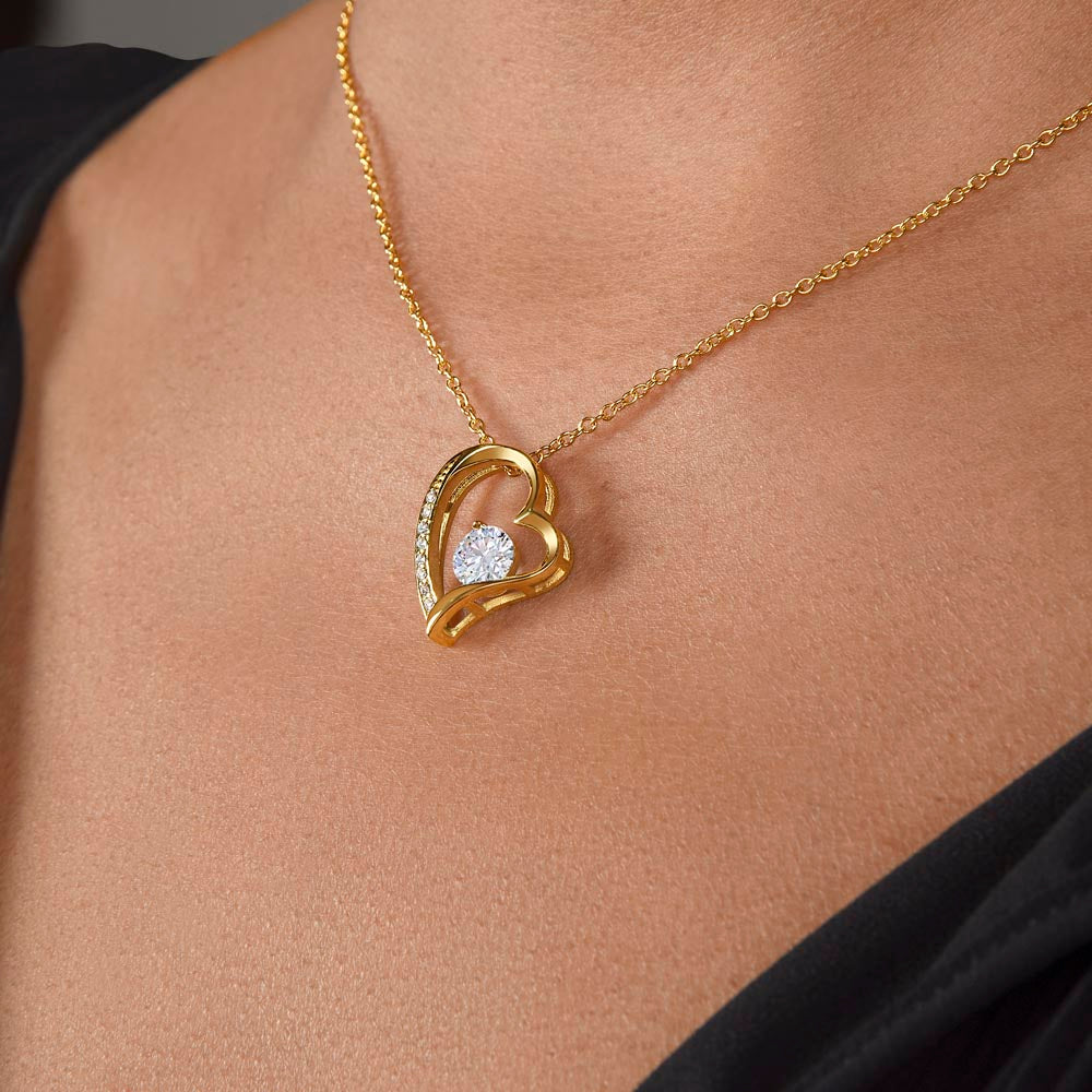 Gold heart pendant necklace with round center stone on fine chain