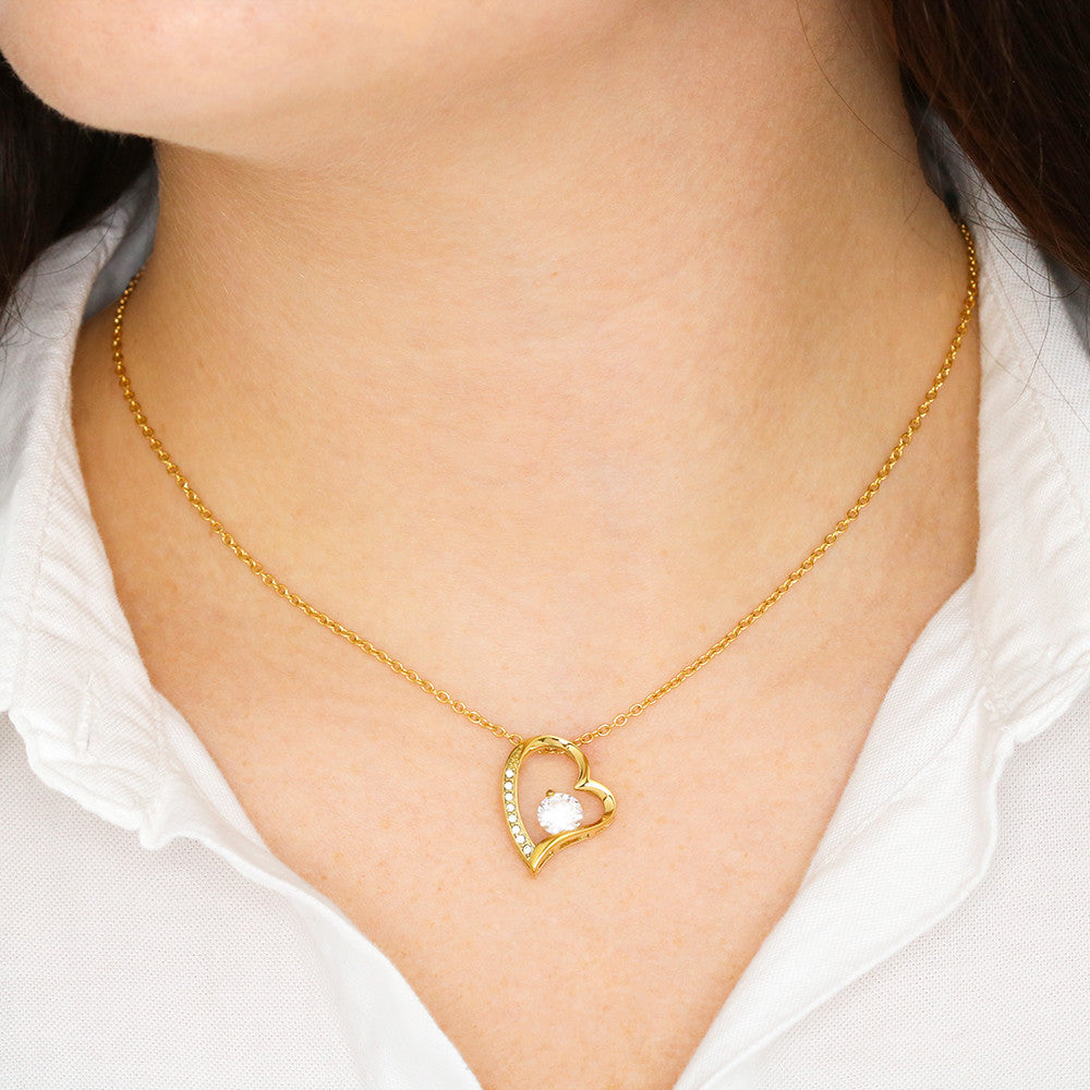 Heart pendant necklace, gold tone chain with small heart pendant and crystal center on wearer