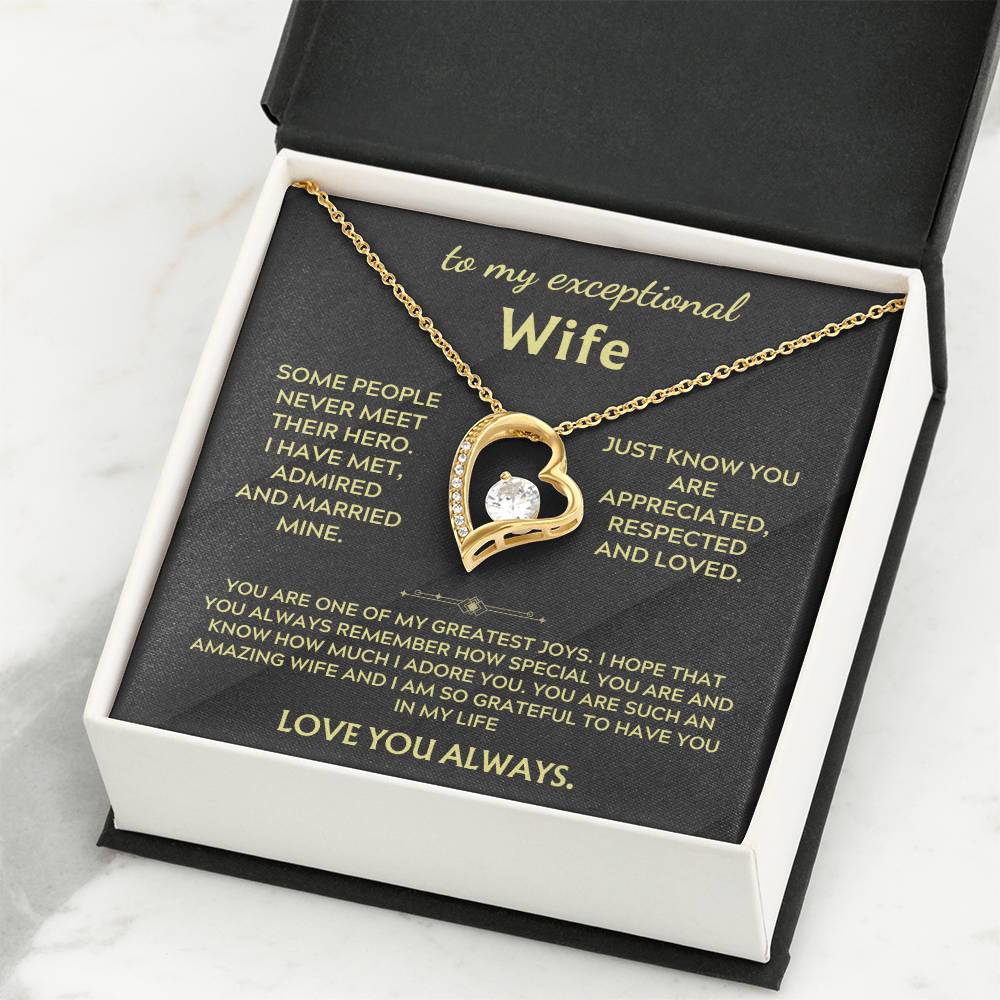 Necklace in white gift box with gold heart pendant and chain on black insert