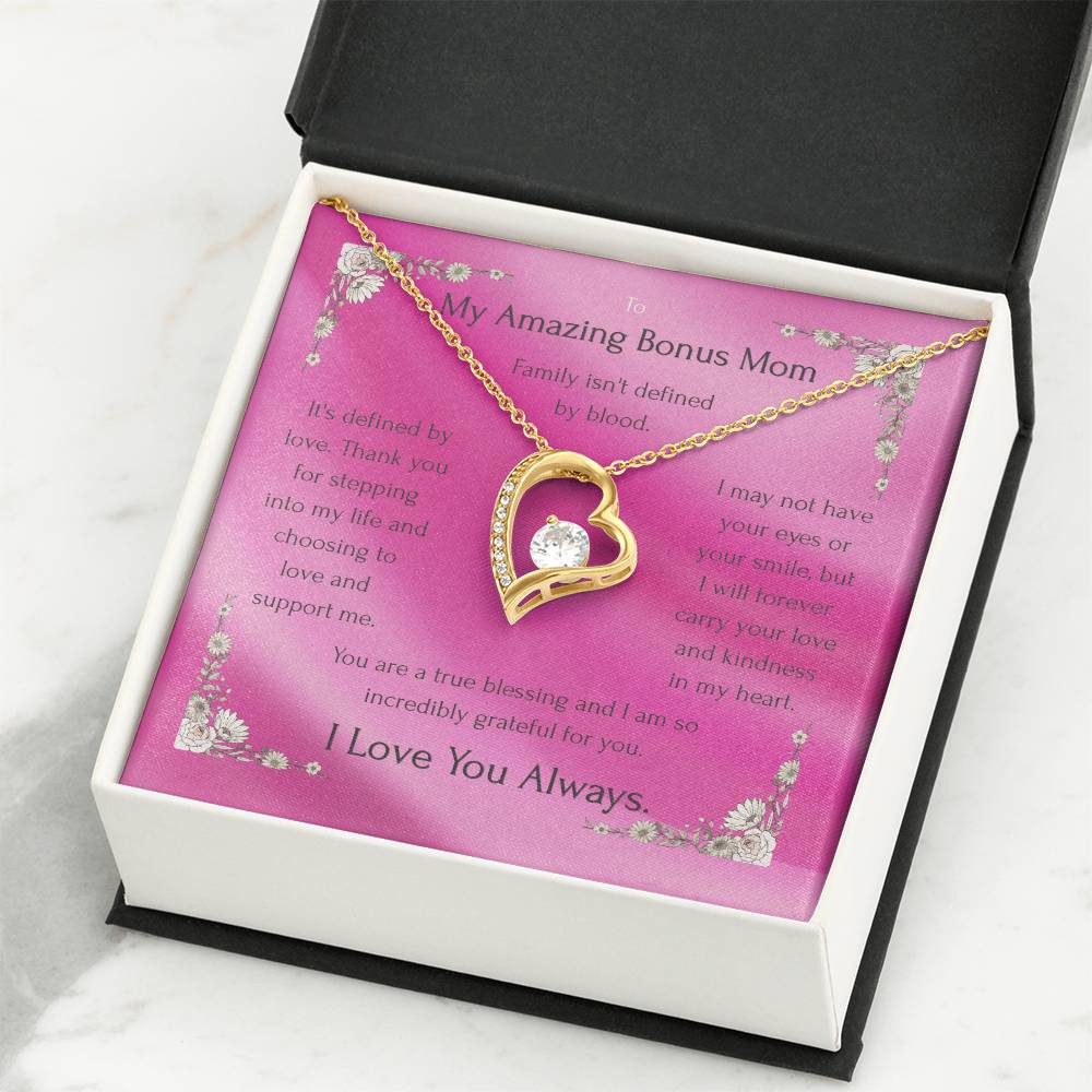 Gold-tone heart pendant necklace with round CZ on pink card inside black box