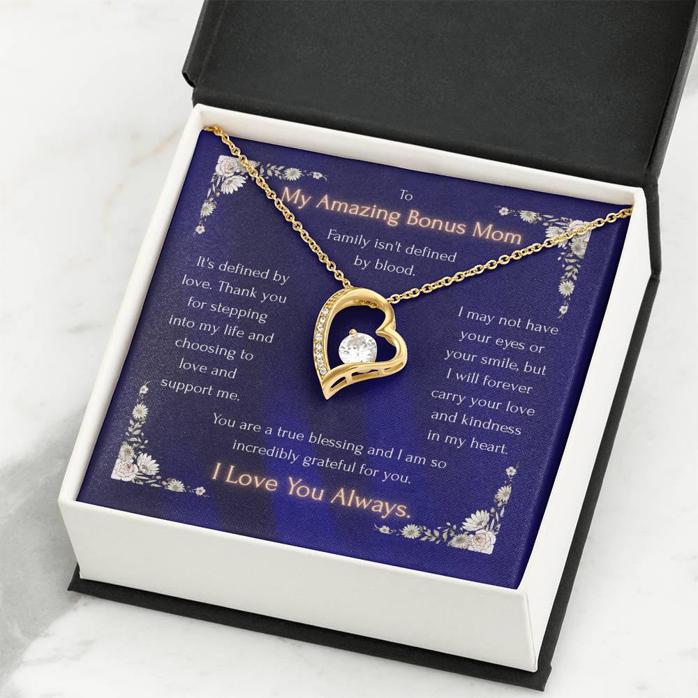 Gold-tone heart pendant necklace displayed in a black gift box