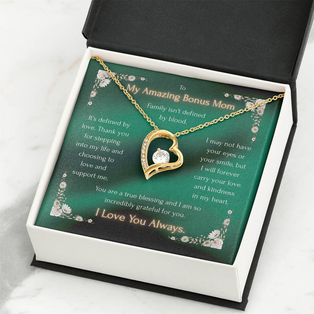 Gold-tone heart pendant necklace on a green message card inside an open gift box