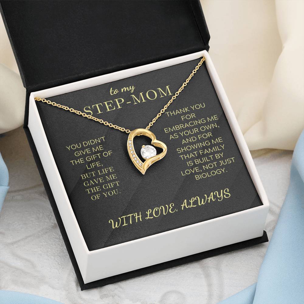 Gold tone heart pendant necklace with round zirconia charm in open gift box