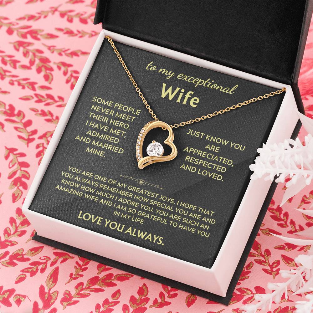 Necklace in pink and white gift box with gold heart pendant and chain on black insert