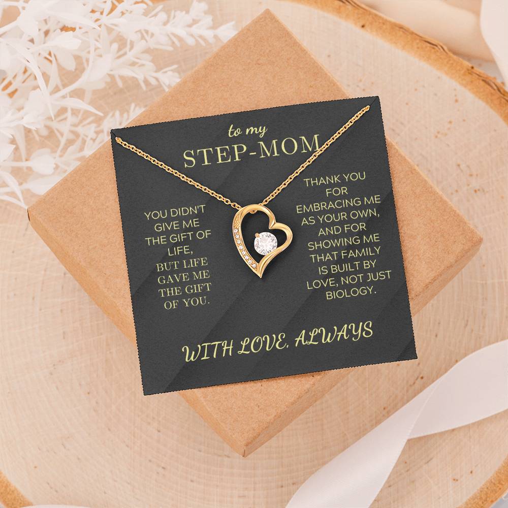 Gold tone heart pendant necklace with round zirconia stone shown on gift card
