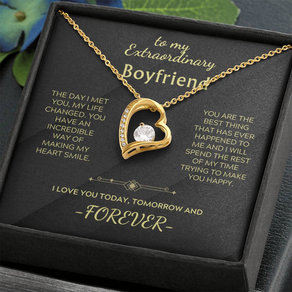 Gold heart pendant necklace with clear stone and gold chain on gift box