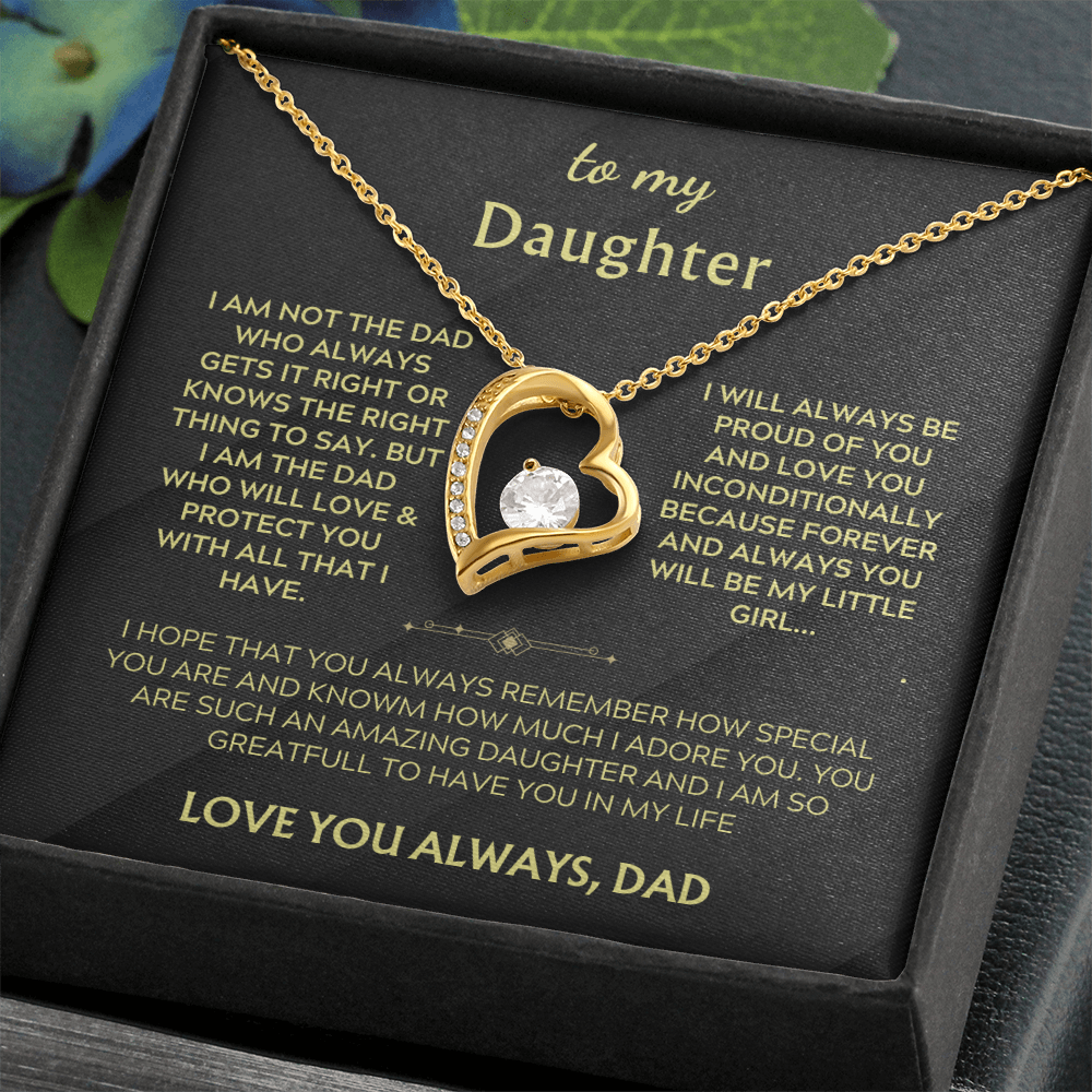 Gold heart pendant necklace with crystal heart on black gift card, chain visible