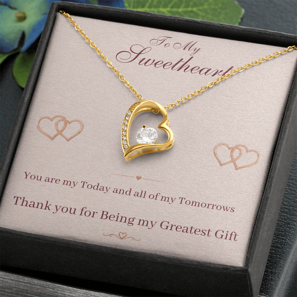 Gold heart pendant necklace with sparkling center stone in gift box and message card