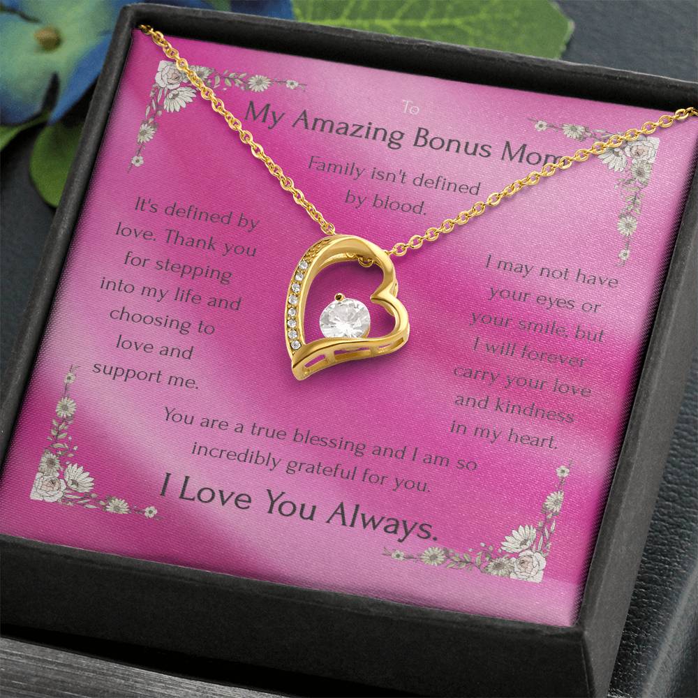 Gold heart pendant necklace with rhinestone outline on a pink message card in box