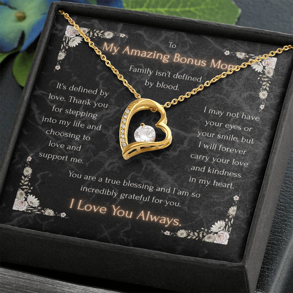 Gold heart pendant necklace with clear center stone on a decorative message card