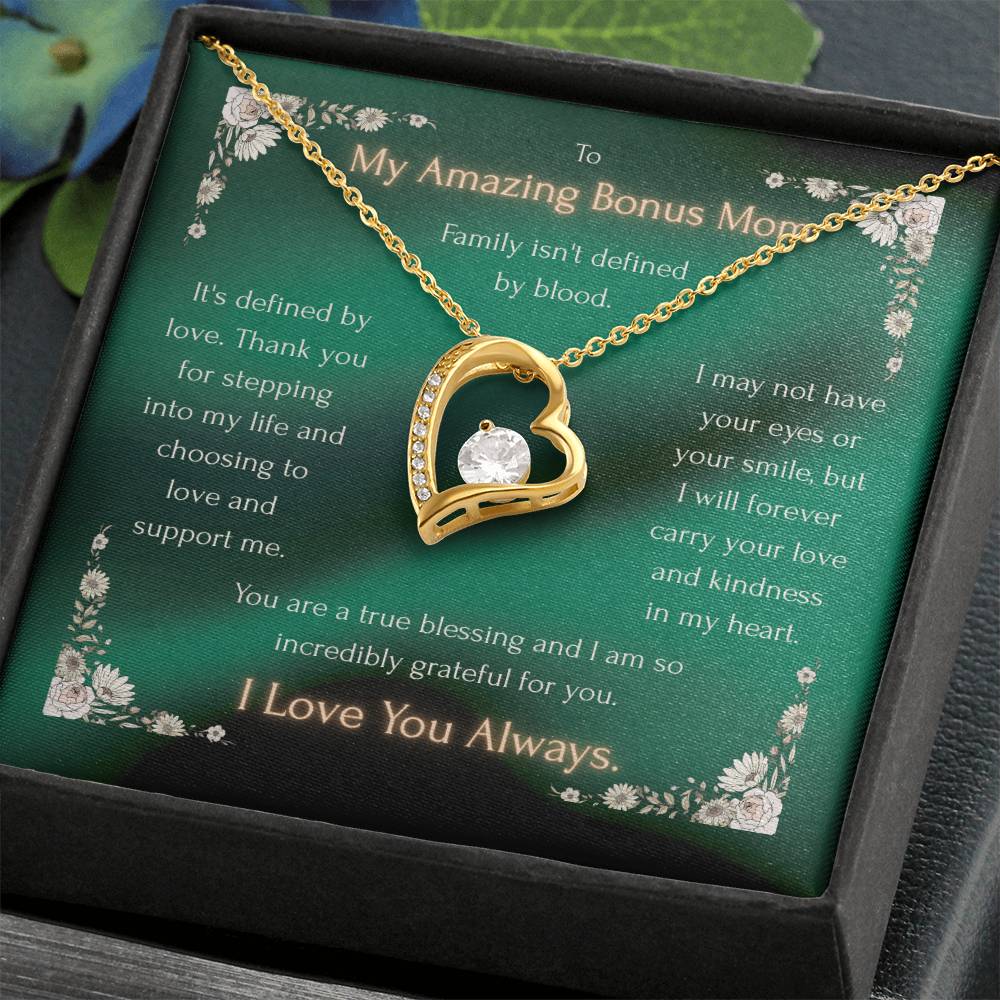 Gold heart pendant necklace with crystal inset and chain, displayed in gift box