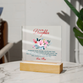 Acrylic keepsake sign with floral print, standing on light wooden base
