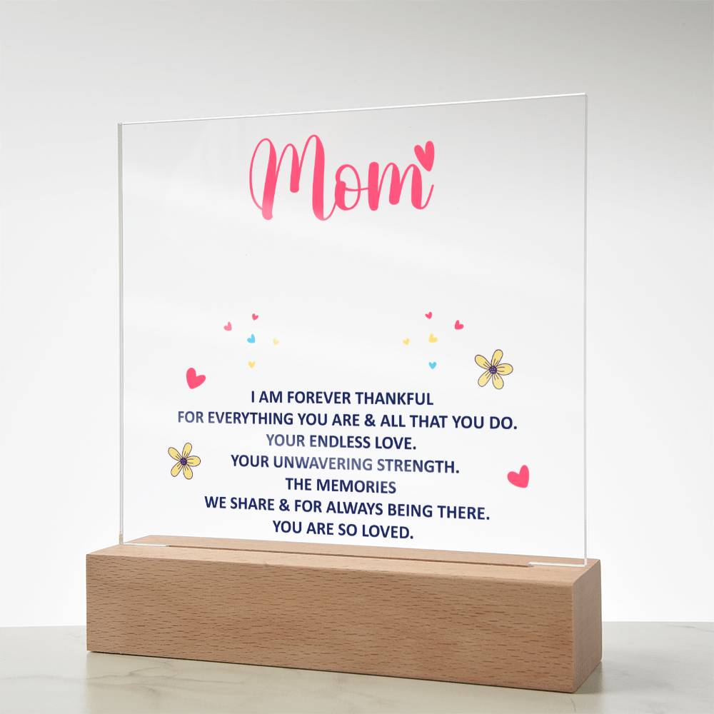 Minimal acrylic “Mom” plaque with quote and small flower icons on wood base