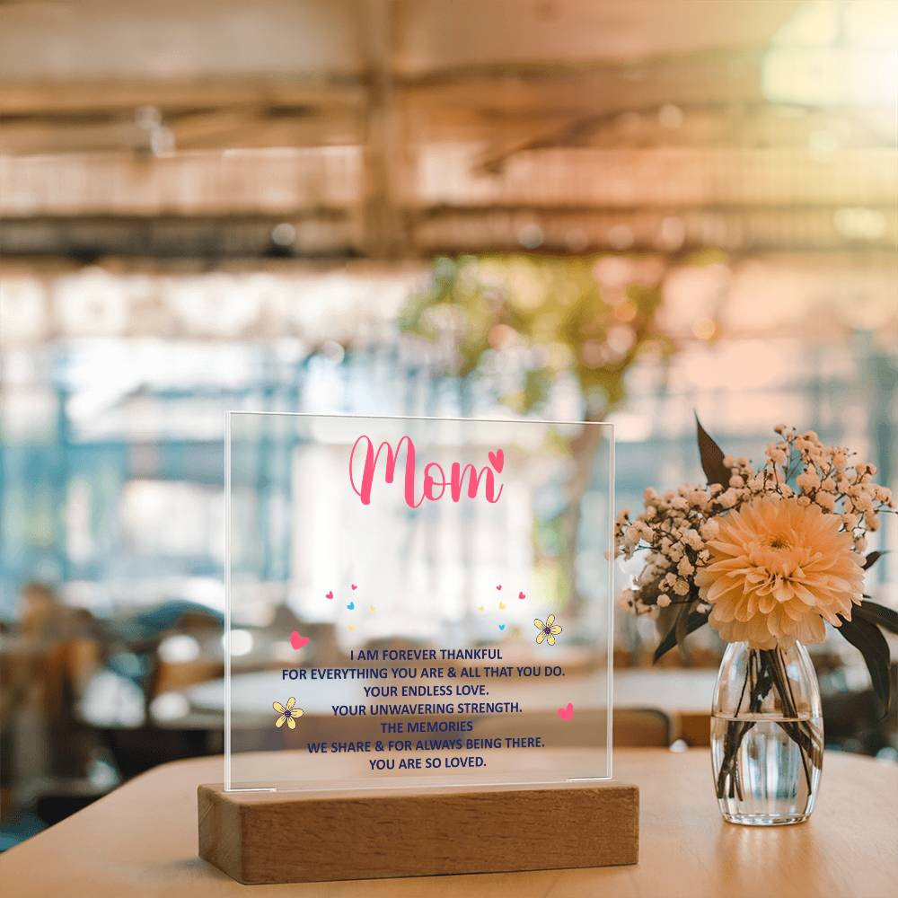Clear acrylic “Mom” keepsake with thankful message and wood base on table