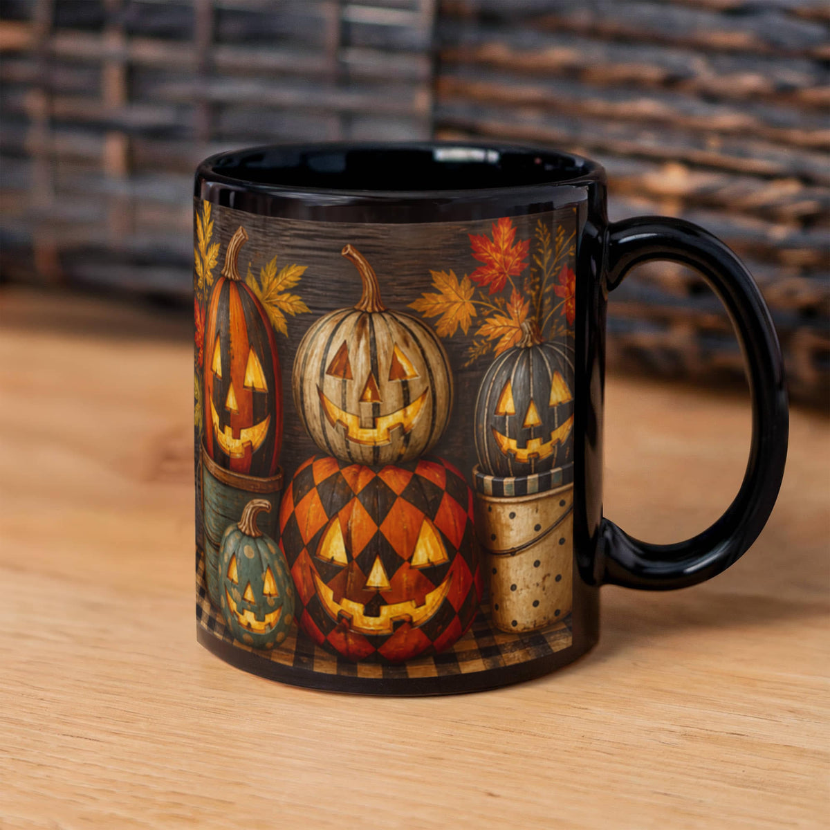 Black ceramic mug with full wrap Halloween pumpkin faces and orange leaf accents