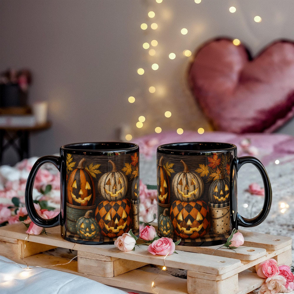 Two black ceramic coffee mugs with matching jack-o'-lantern Halloween pumpkin prints