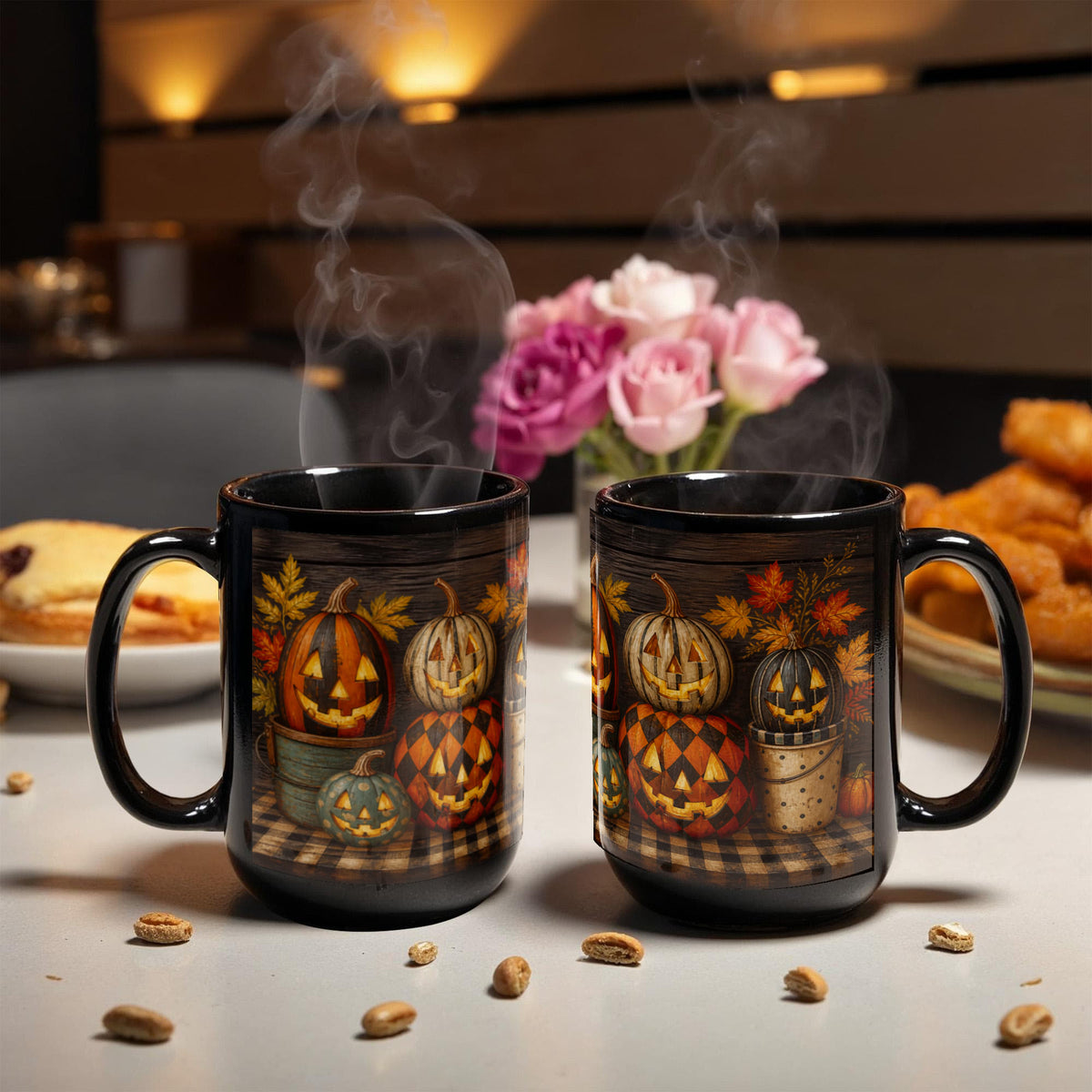 Pair of black ceramic coffee mugs with jack-o'-lantern pumpkin artwork, side by side
