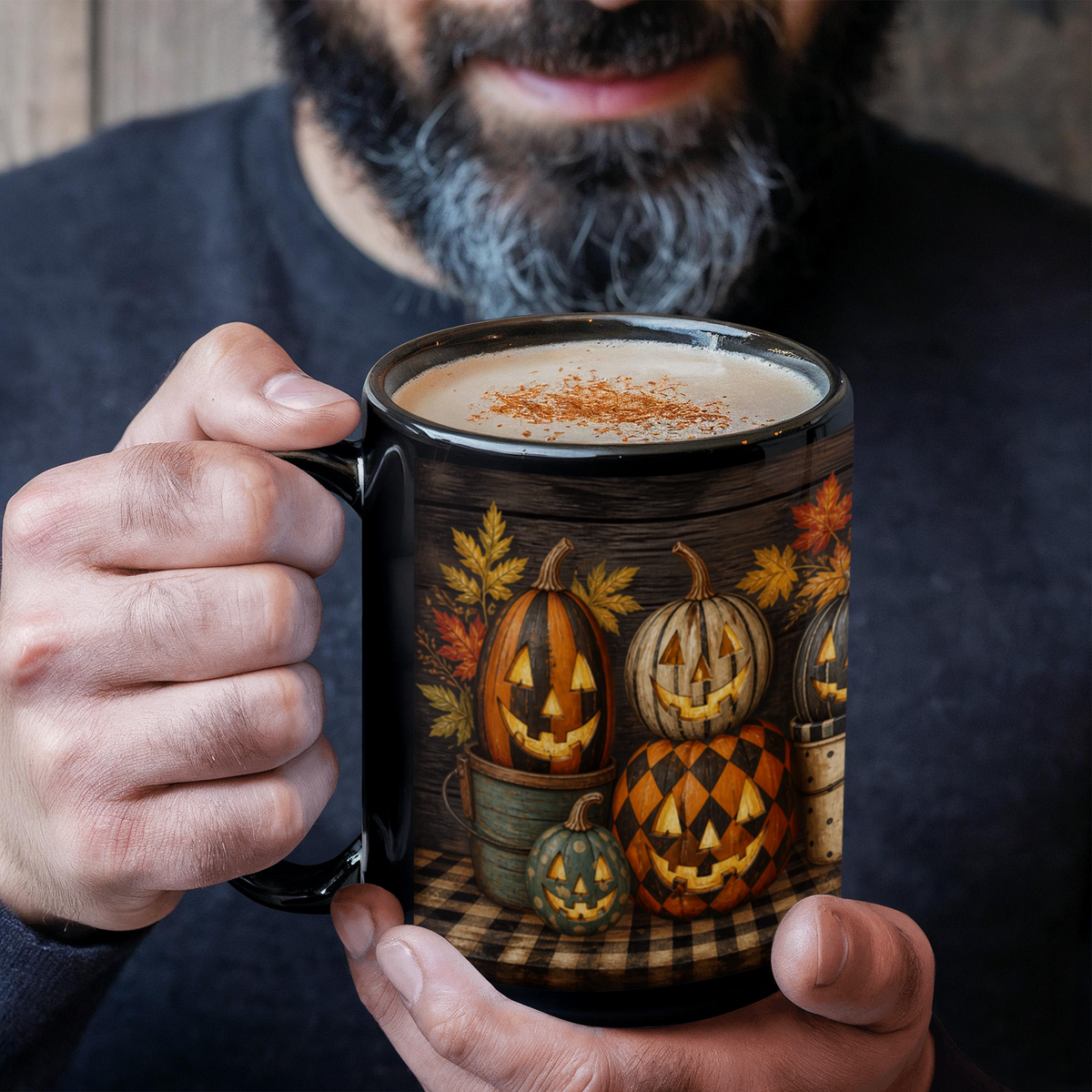 Black ceramic coffee mug with jack-o'-lantern full-wrap print and coffee foam on top